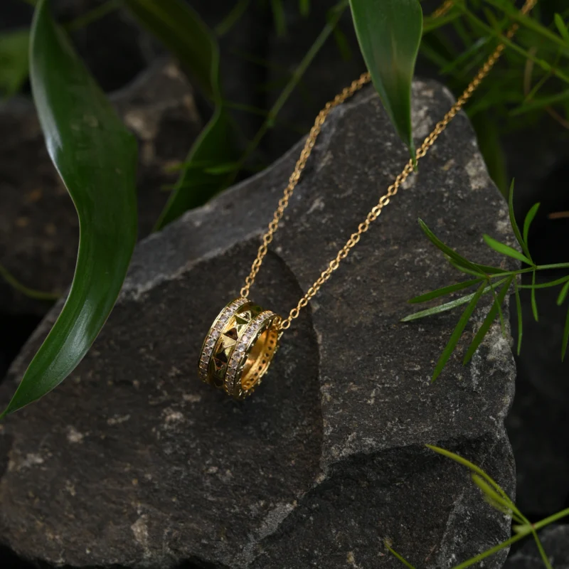 Gold Dual-Ring Pendant with Pyramid Studs and Crystal Borders - Image 2
