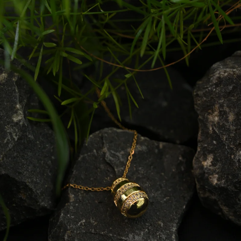 Gold Striped Egg Pendant with Crystal Embellishments - Image 2