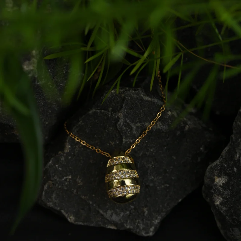 Gold Striped Egg Pendant with Crystal Embellishments
